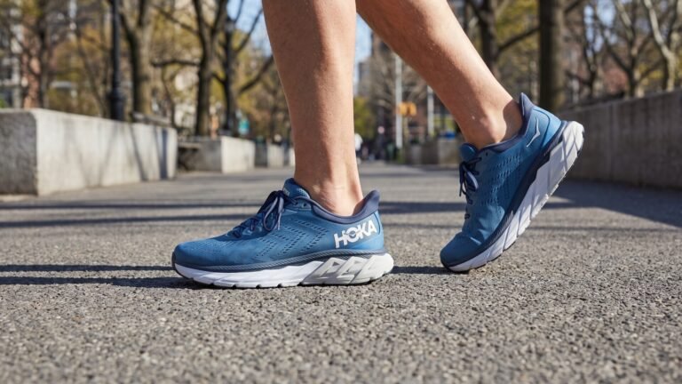 Runner wearing blue Hoka Arahi stability running shoes while striding along a paved outdoor path