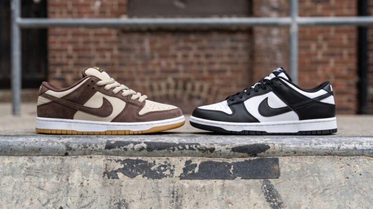 Nike SB Dunk Low in brown and tan facing a black and white Nike Dunk Low on a concrete ledge