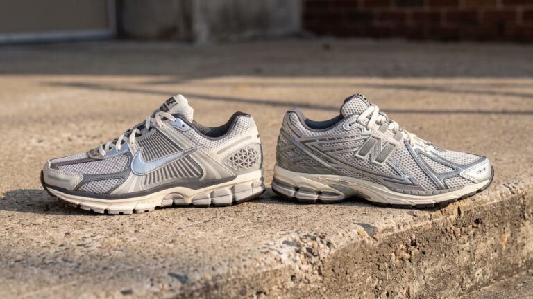 Nike Zoom Vomero 5 and New Balance 1906R sneakers side by side on a concrete curb