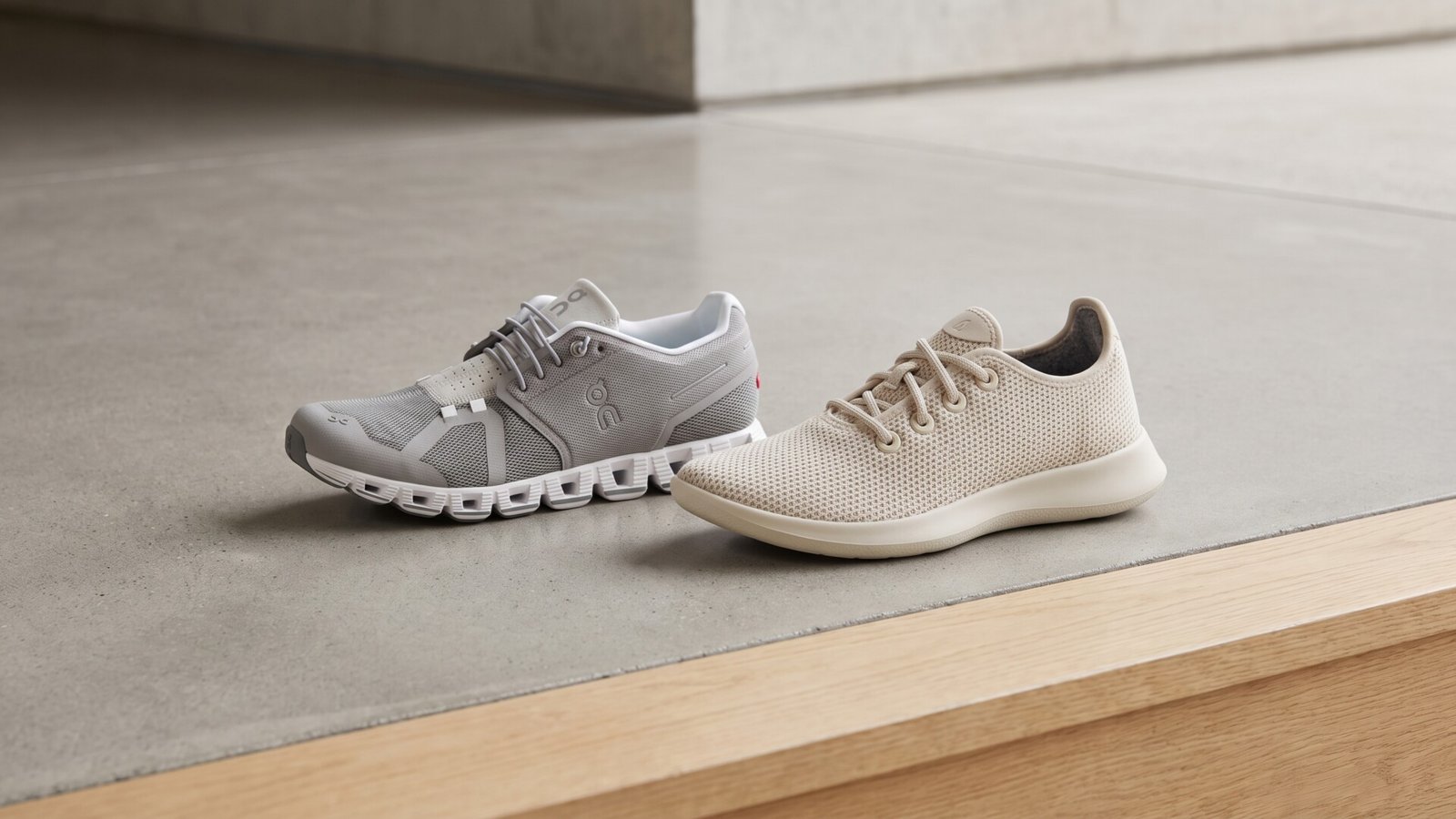 Grey On Cloud 5 sneaker beside a beige Allbirds Tree Runner sneaker on a neutral concrete surface