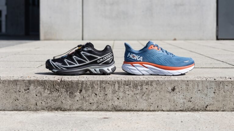 Black Salomon XT-6 trail runner side by side with a blue and orange Hoka Clifton sneaker on a concrete ledge