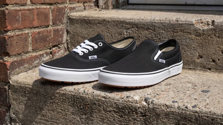 Black Vans Authentic sneaker alongside a black Vans Slip-On shoe resting on an outdoor concrete step